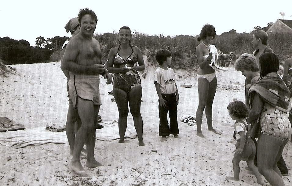 Captain Jack Faletti, and Eileen, , with Gail Freedman and John Faletti talking, while the Booth Cottage beach crew look on. Brewster MA circa 1978