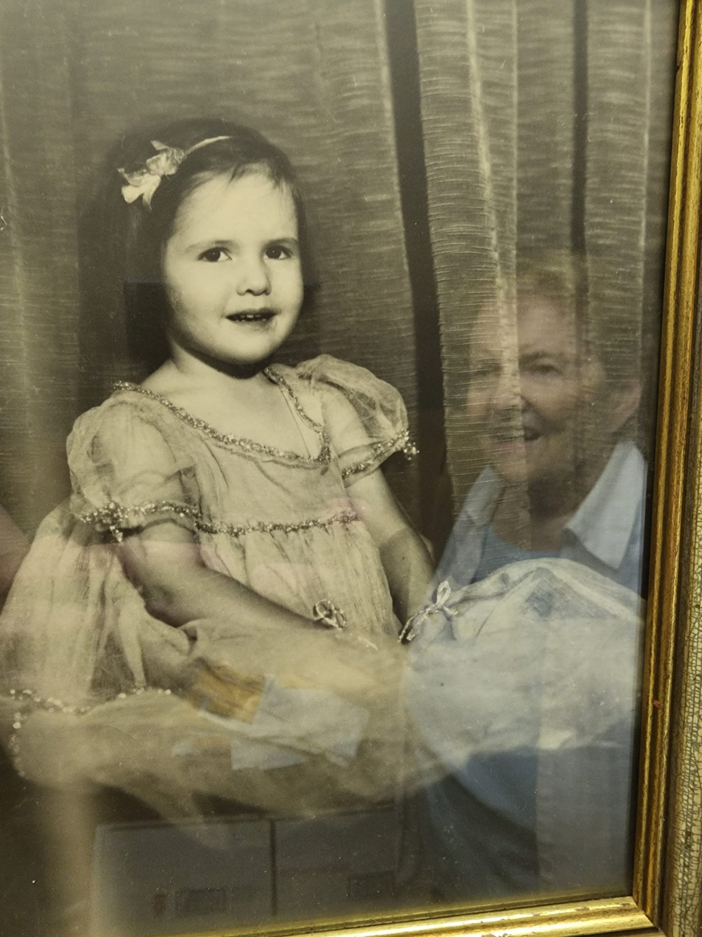 Mary (2023) reflected in photo of young Mary, Pawlet, VT