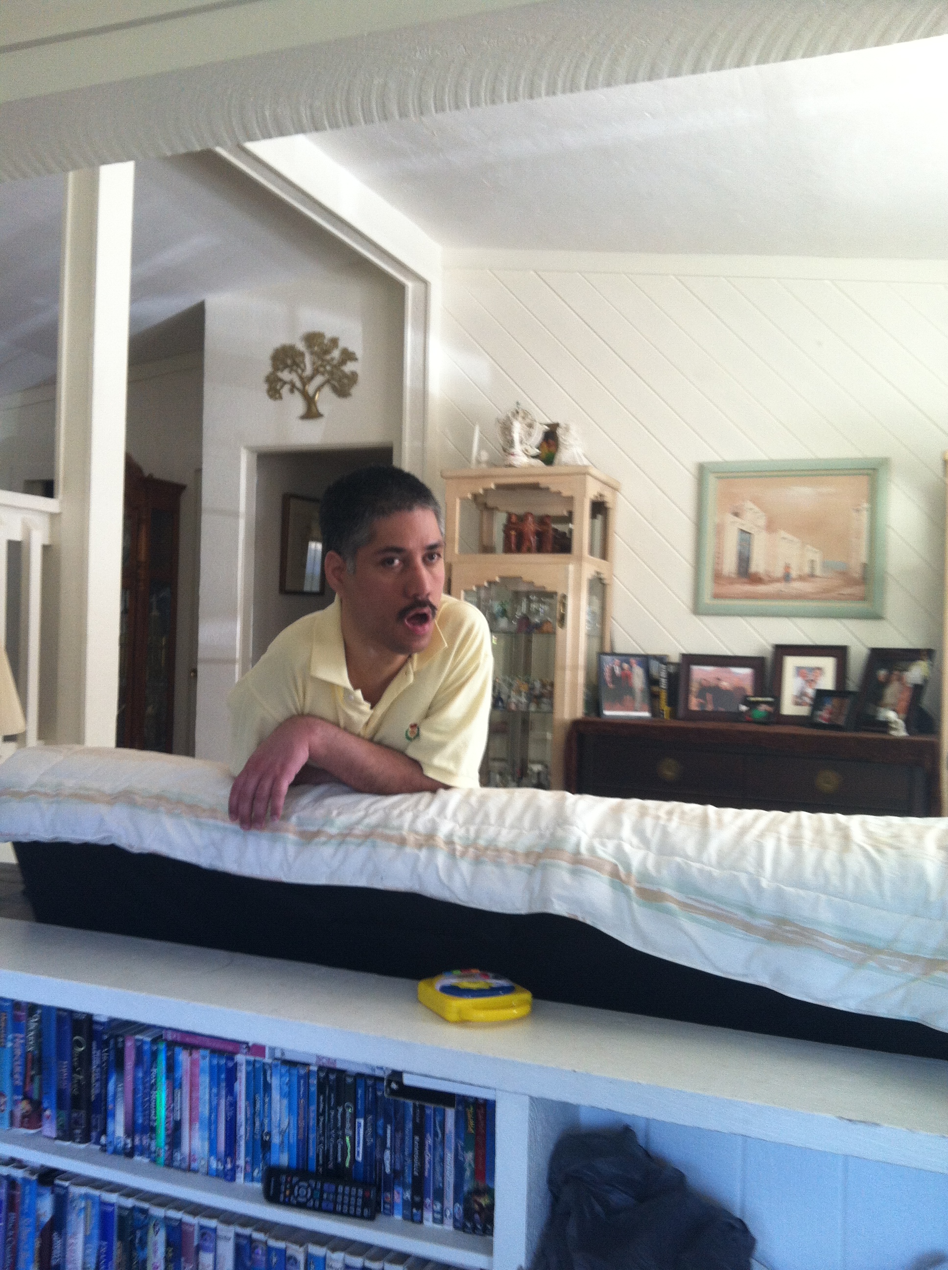 Hanging over the couch to watch tv