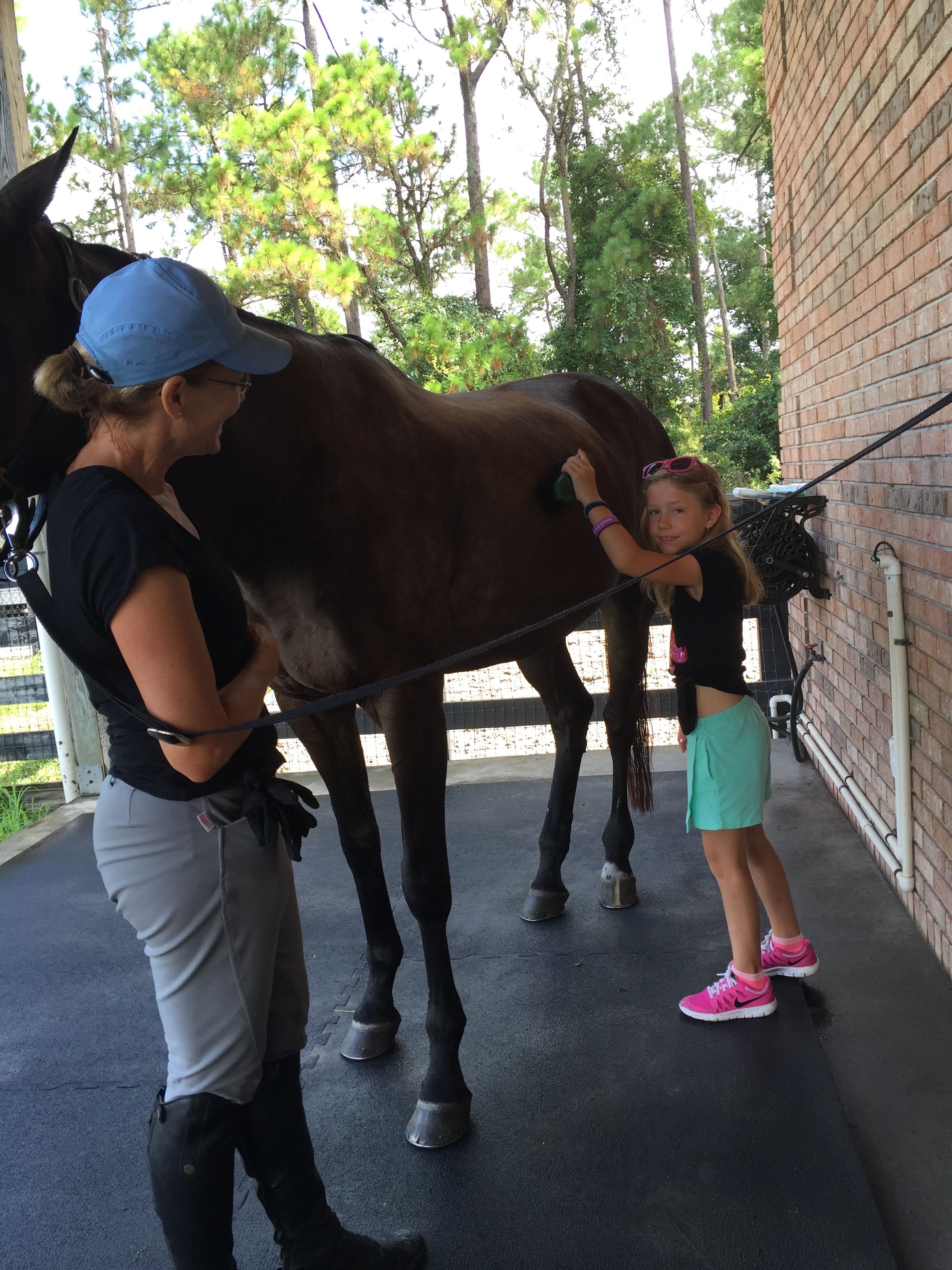 Amy sharing her love of horses with my daughter Annie, another horse-lover.