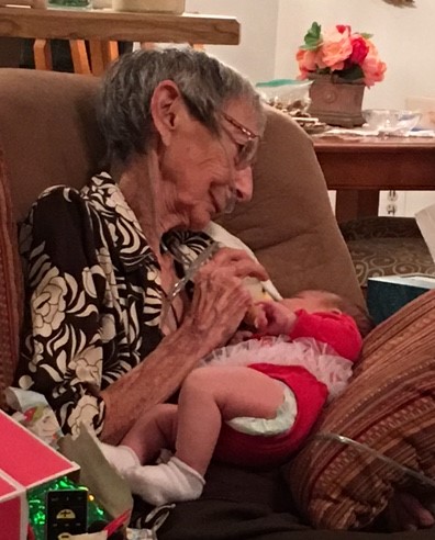Feeding her newest great-granddaughter Audrey
