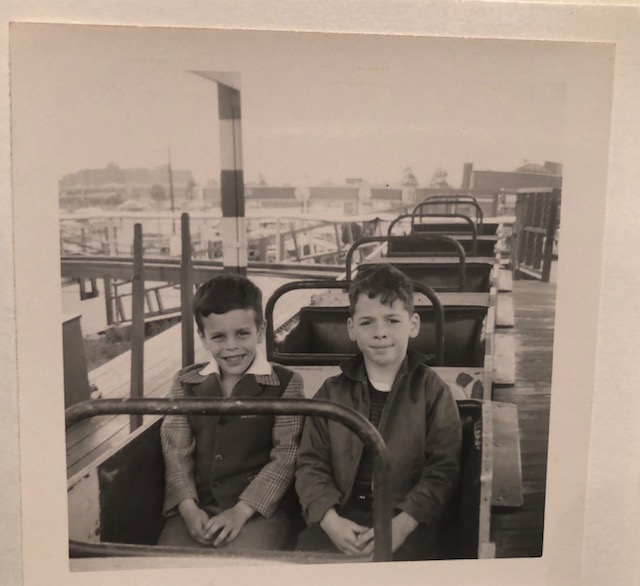 Howard, at age 7, and me (cousin Jay) share a roller coaster. He is the happy one. It seemed that he was always happy.