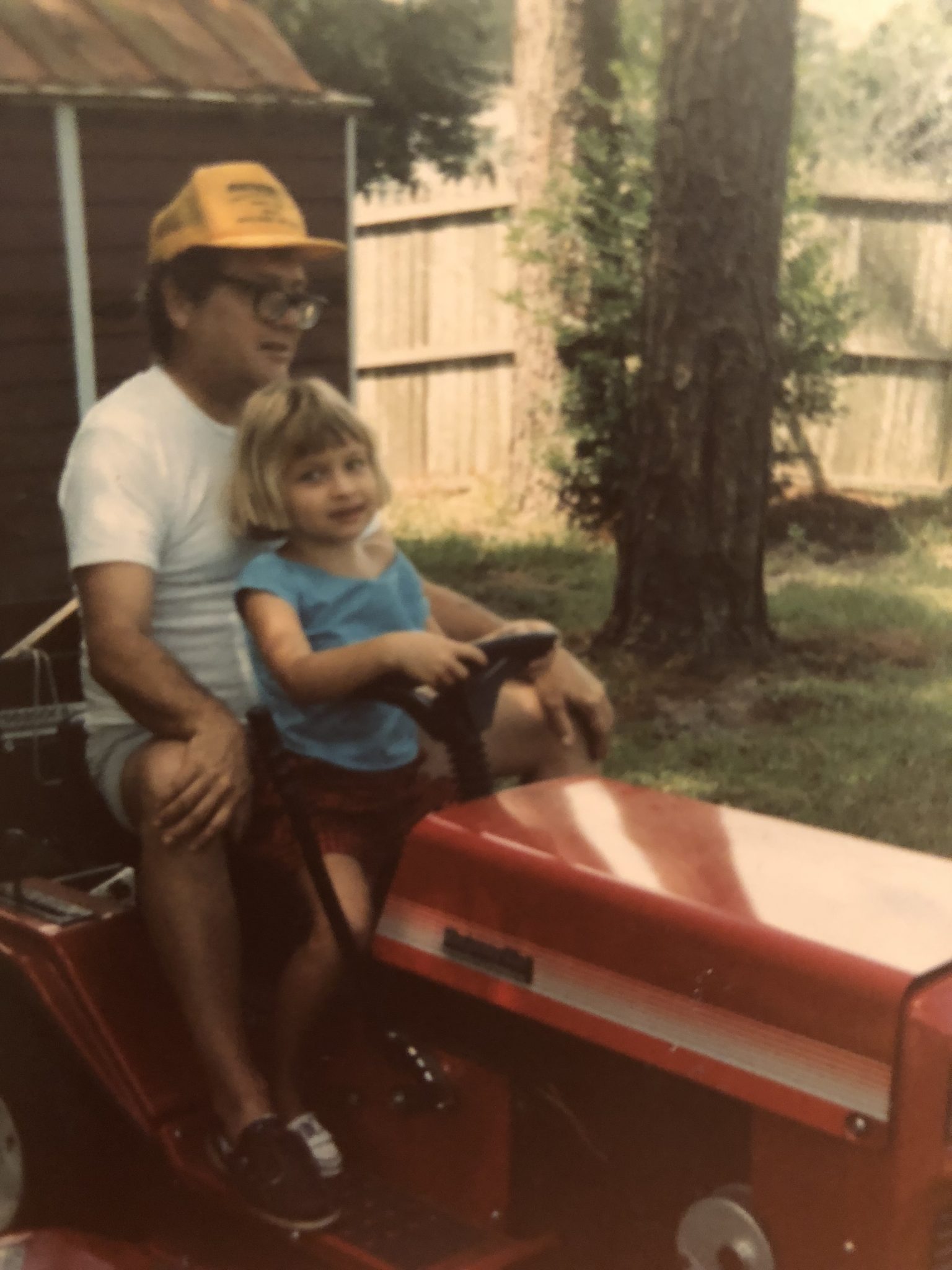 My dad and I riding our beloved lawnmower.