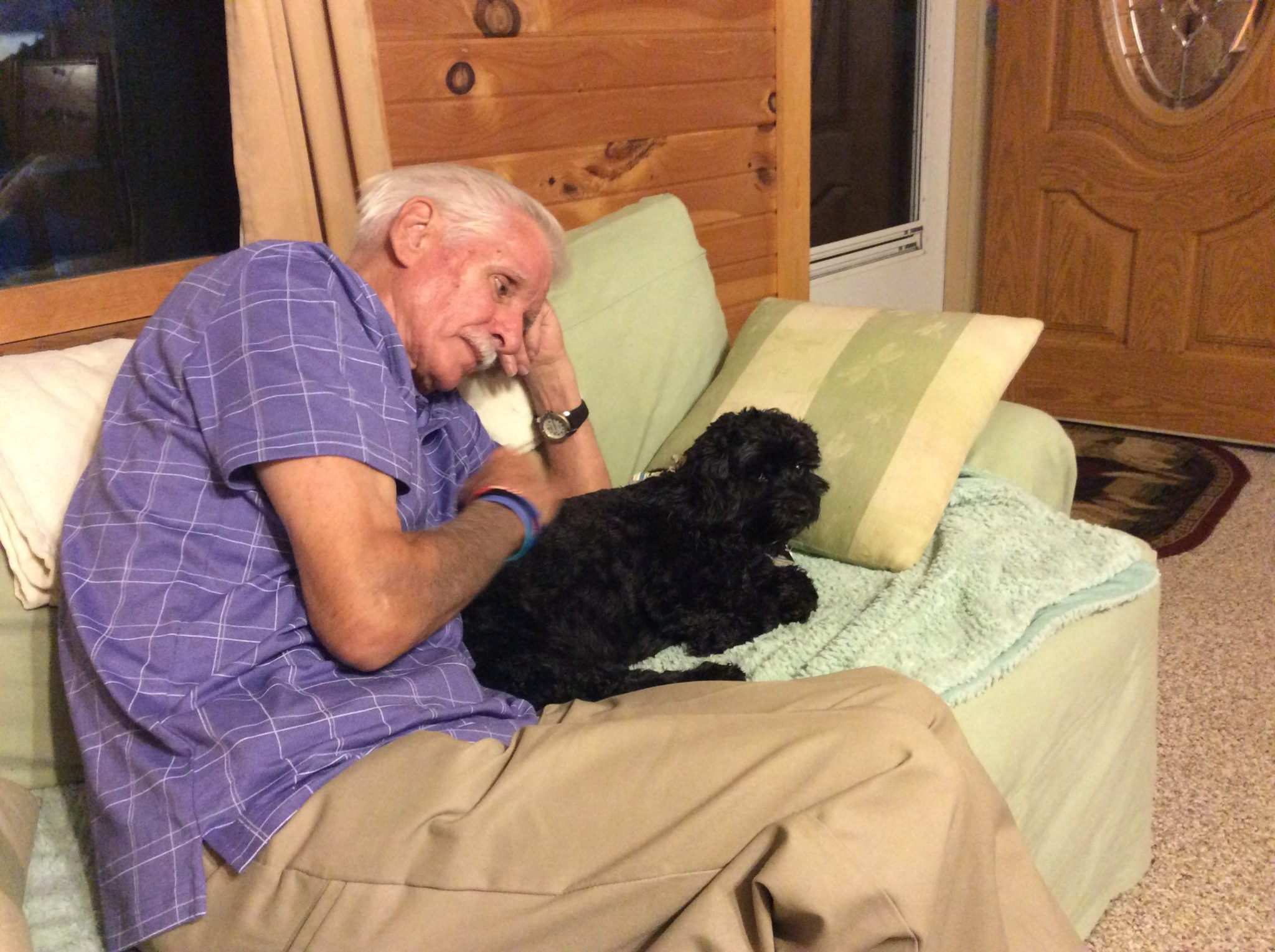 We are so grateful that Val and Bill were able to visit us last summer. This photo of him with our cockerpoo Holly captures his sweet soul so well. We will miss him so much. Our deepest condolences go out to Val and the whole family.