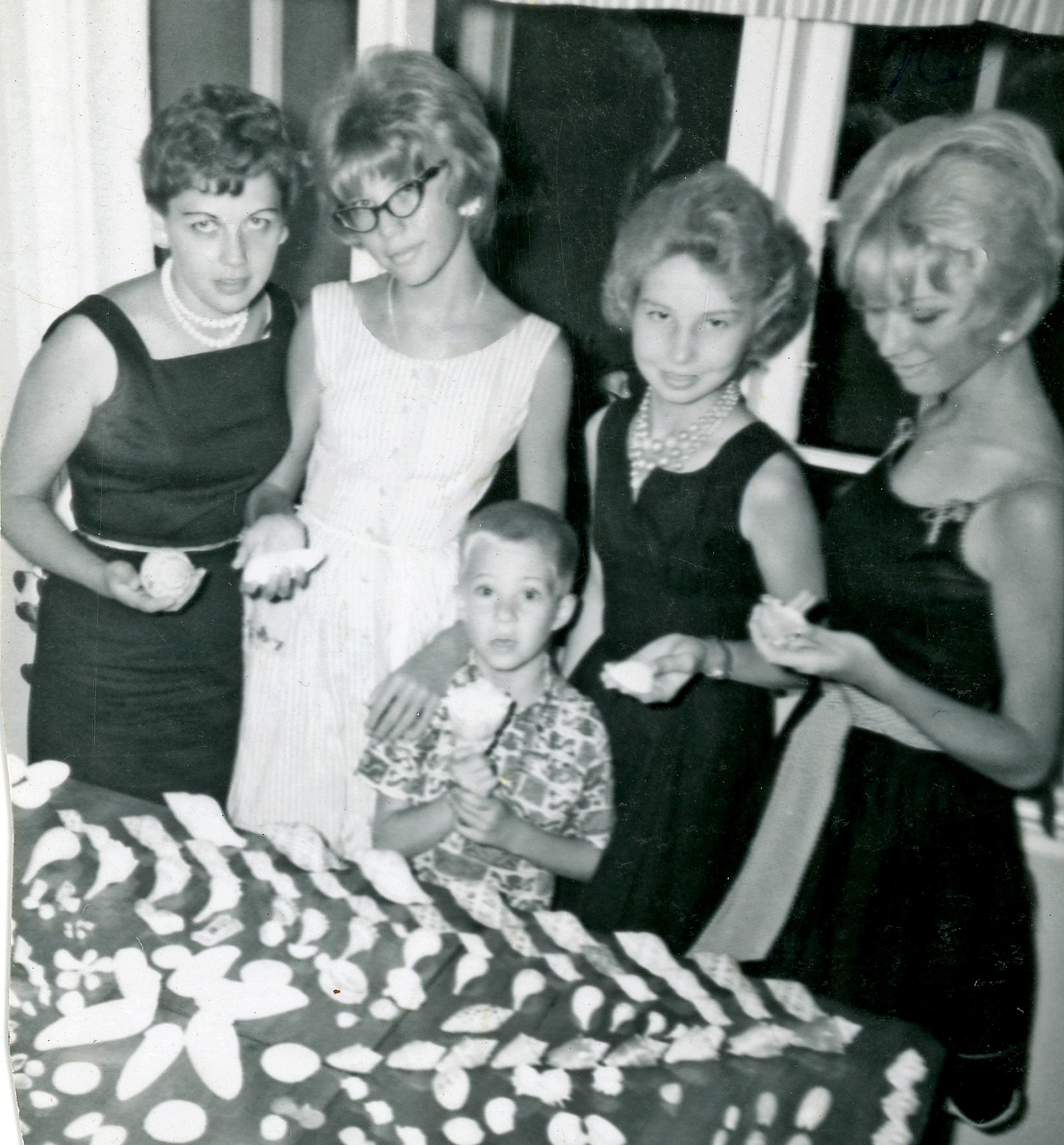 That's Joan on the left with her sisters Tina beside her and Becky on the end. Don't know who the other woman is. The little guy is me. Frankly, I think I'm more properly outfitted for displaying shells than the lovely ladies.
