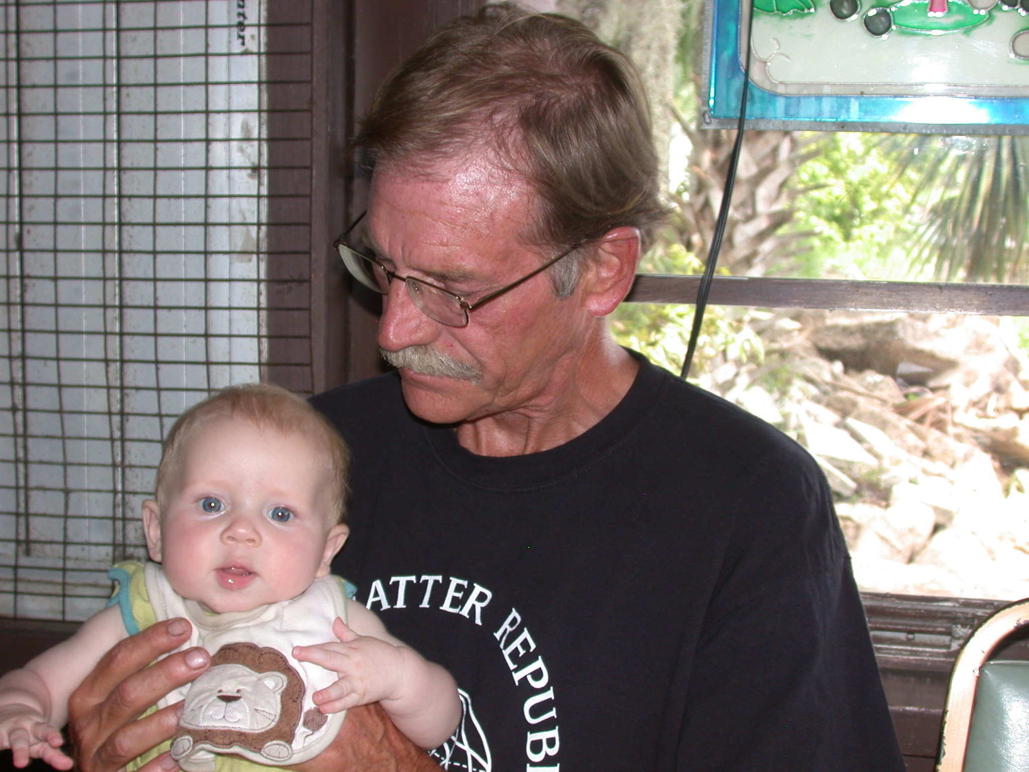 Larry, holding his first grandchild. We will miss you.