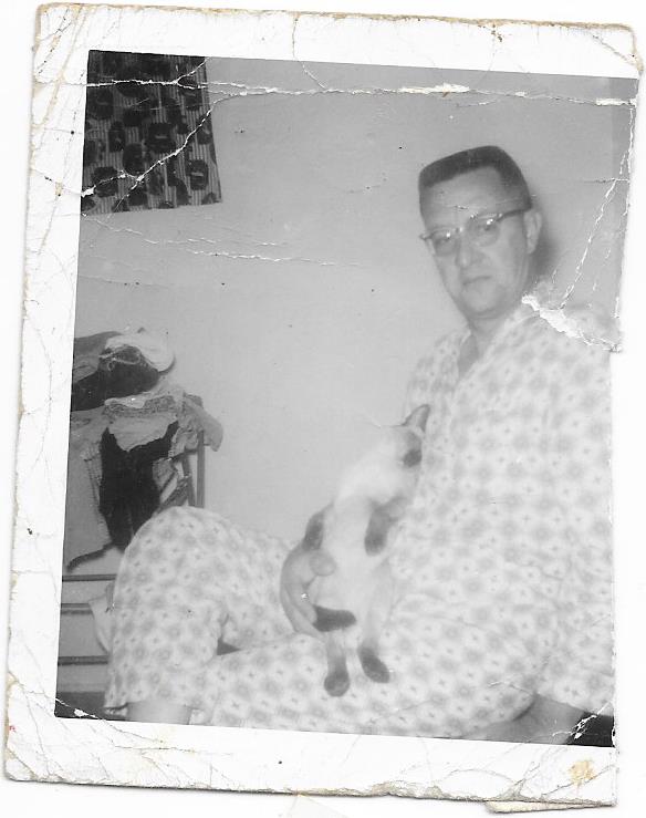 Victors father with Corky the siamese cat in his lap. Corky was Victors cat but also loved Dad.