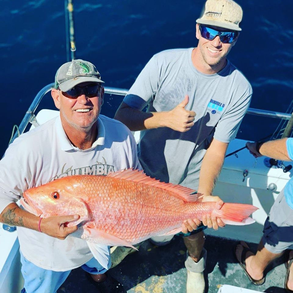 Mark winning the Rolling Red Snapper Jackpot of $259 with a 25.9 pound red snapper, John (mate on Ocean Obsession) standing with him.