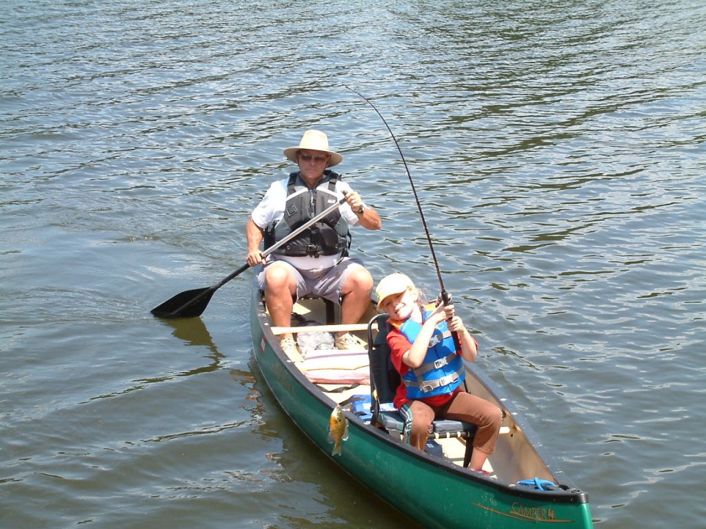 Teaching his granddaughter to canoe and fish
