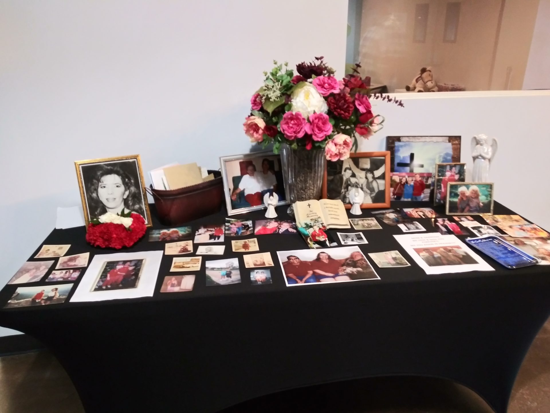 Table of Pictures of Evelyn's Life, Family and Friends at Memorial.