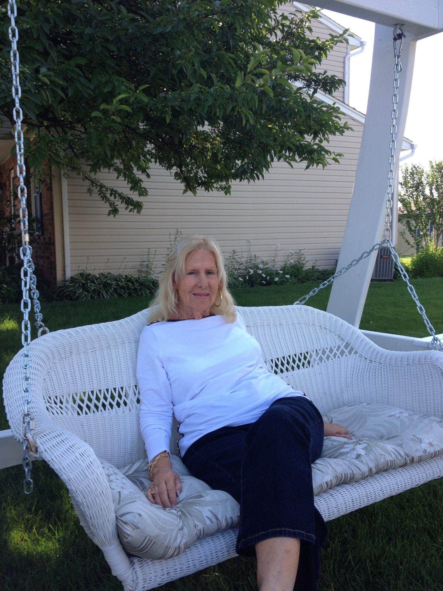 Mom enjoying the weather on her swing