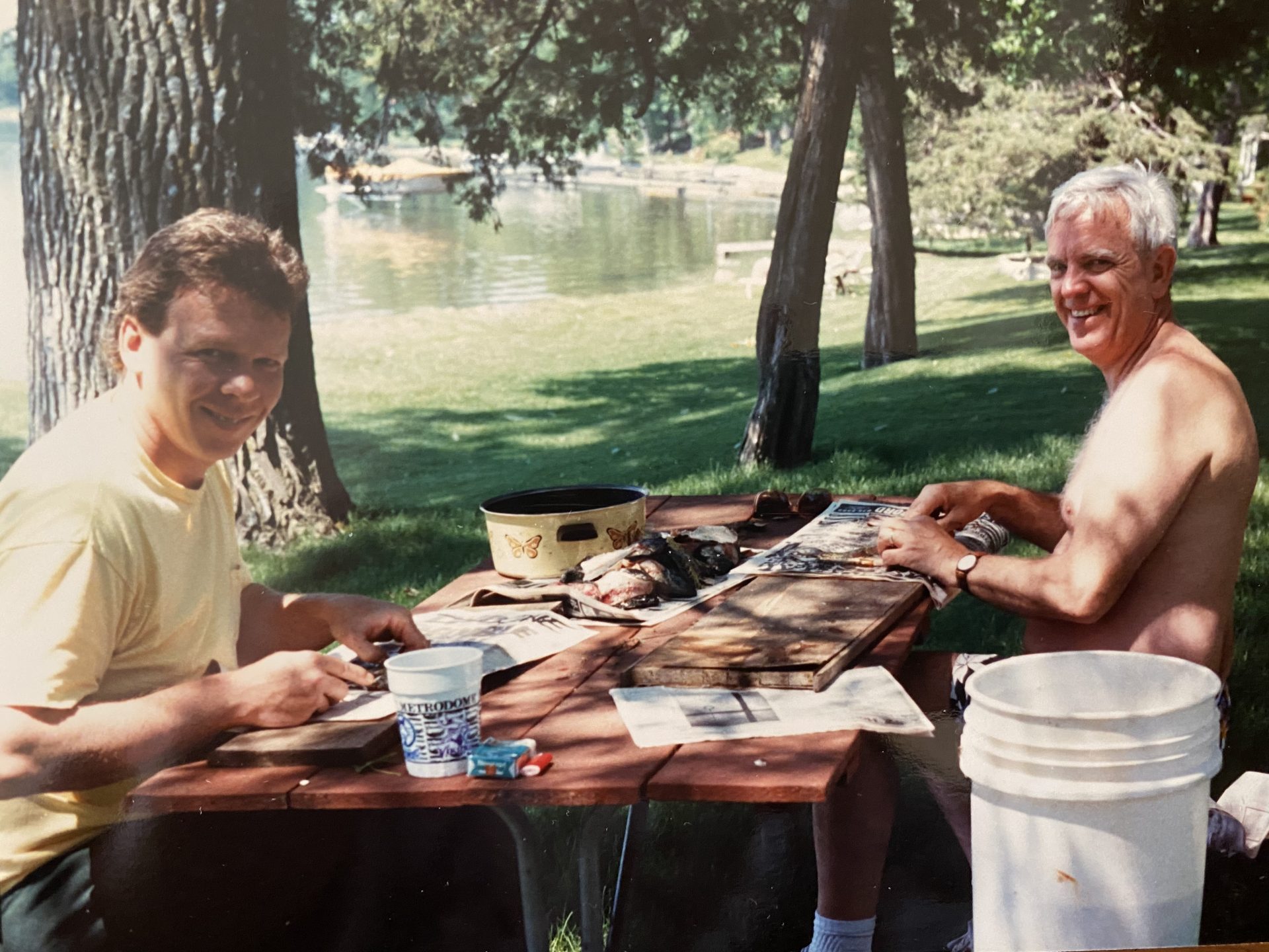Dad and Jim cleaning fish after a good day of fishing on the lake in Minnesota.
