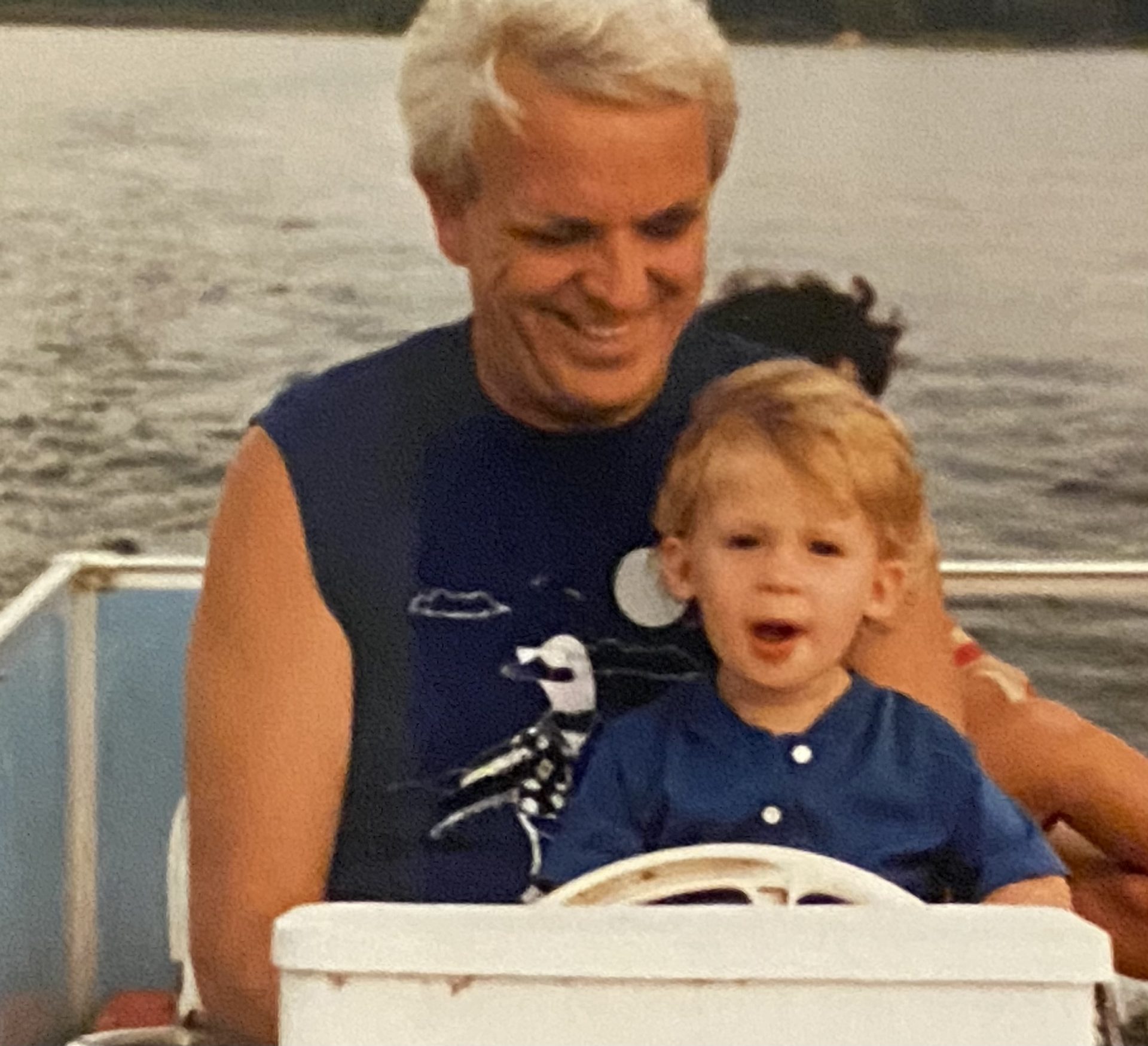 Dad and his grandson Michael steering the pontoon boat on the lake in Minnesota. We spent many a weeks up there enjoying the lake while Michael was growing up.