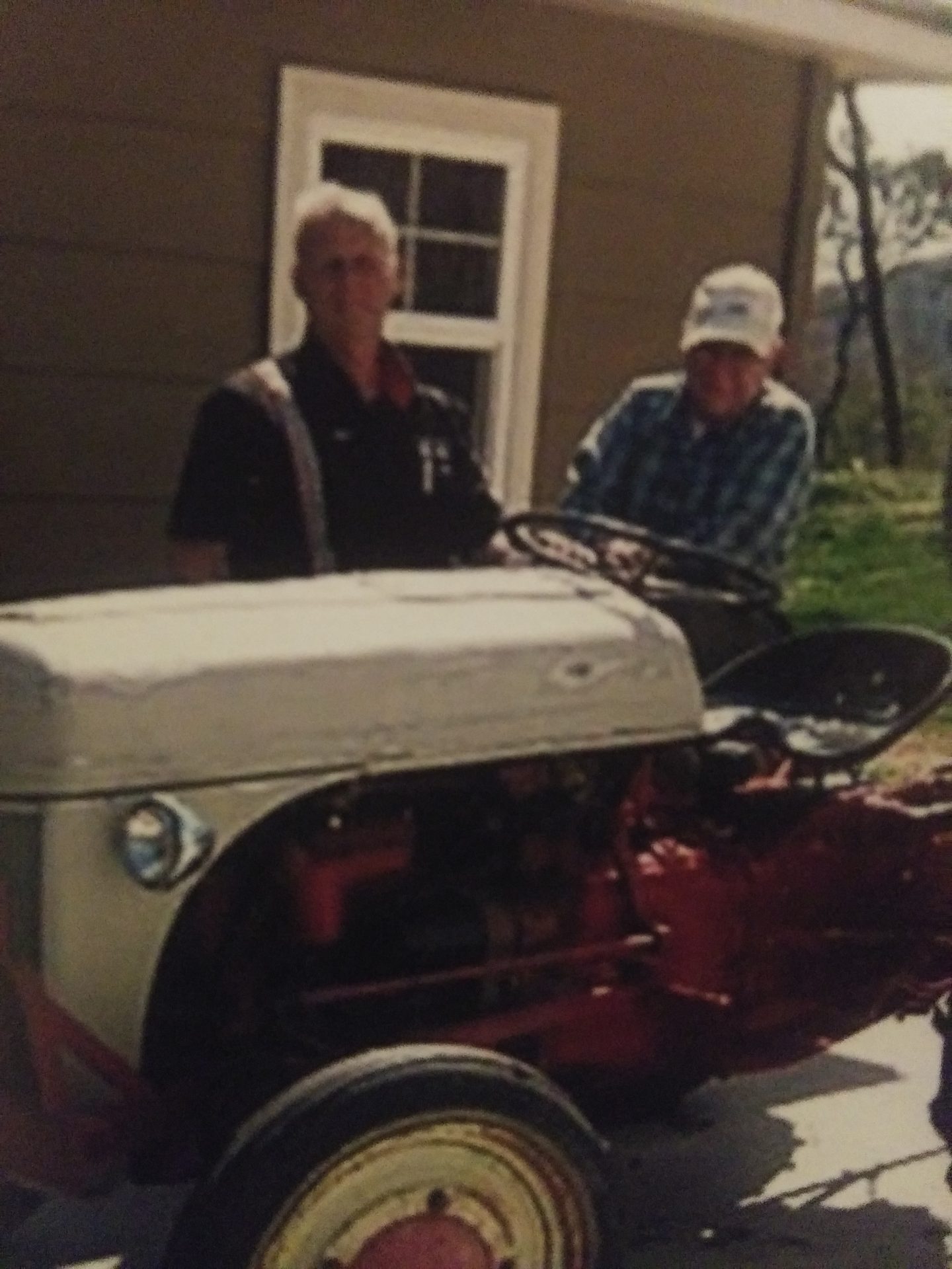 Dad and Joe working on antique tractor