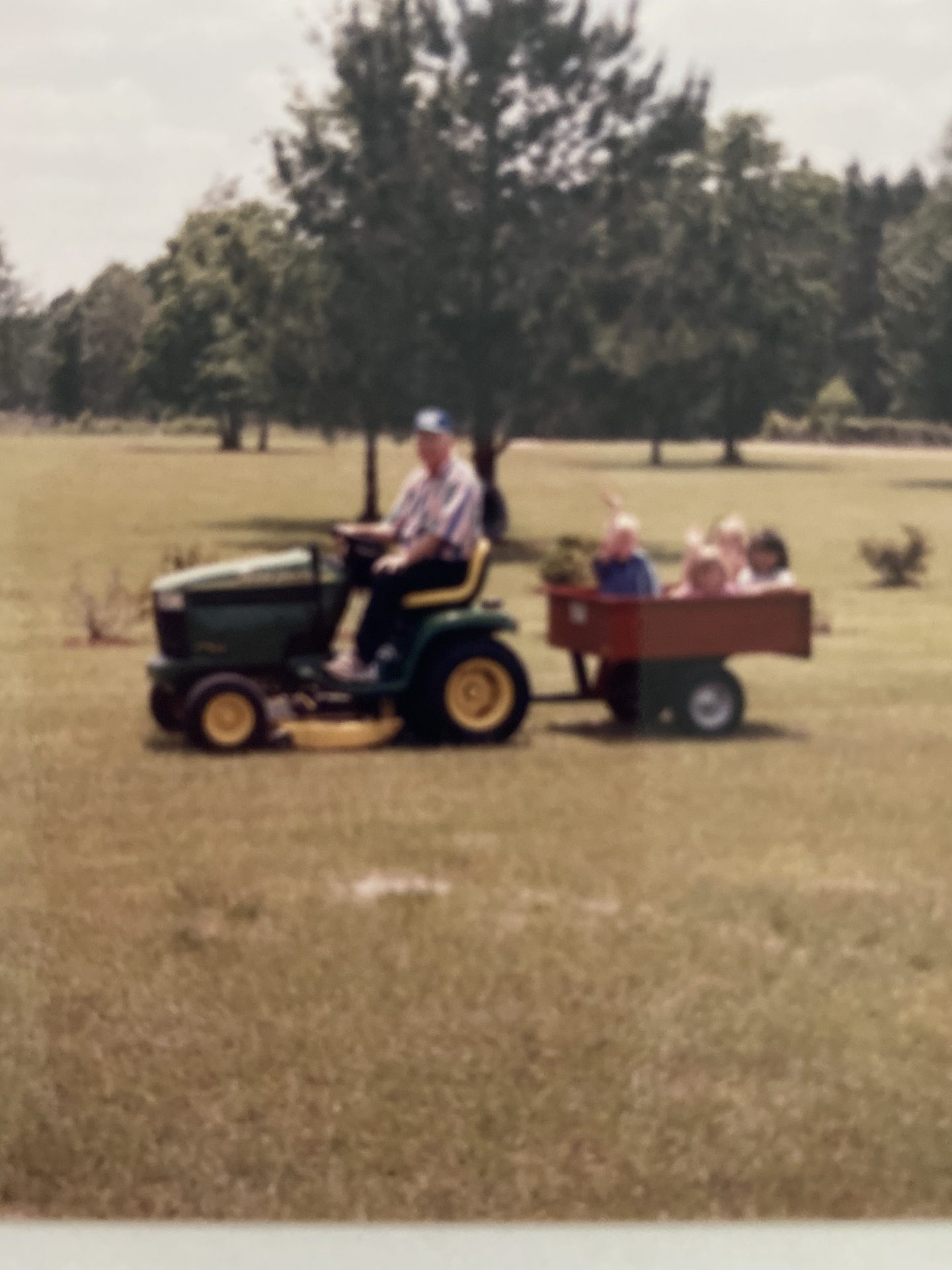His John Deere taking grandkids for a ride