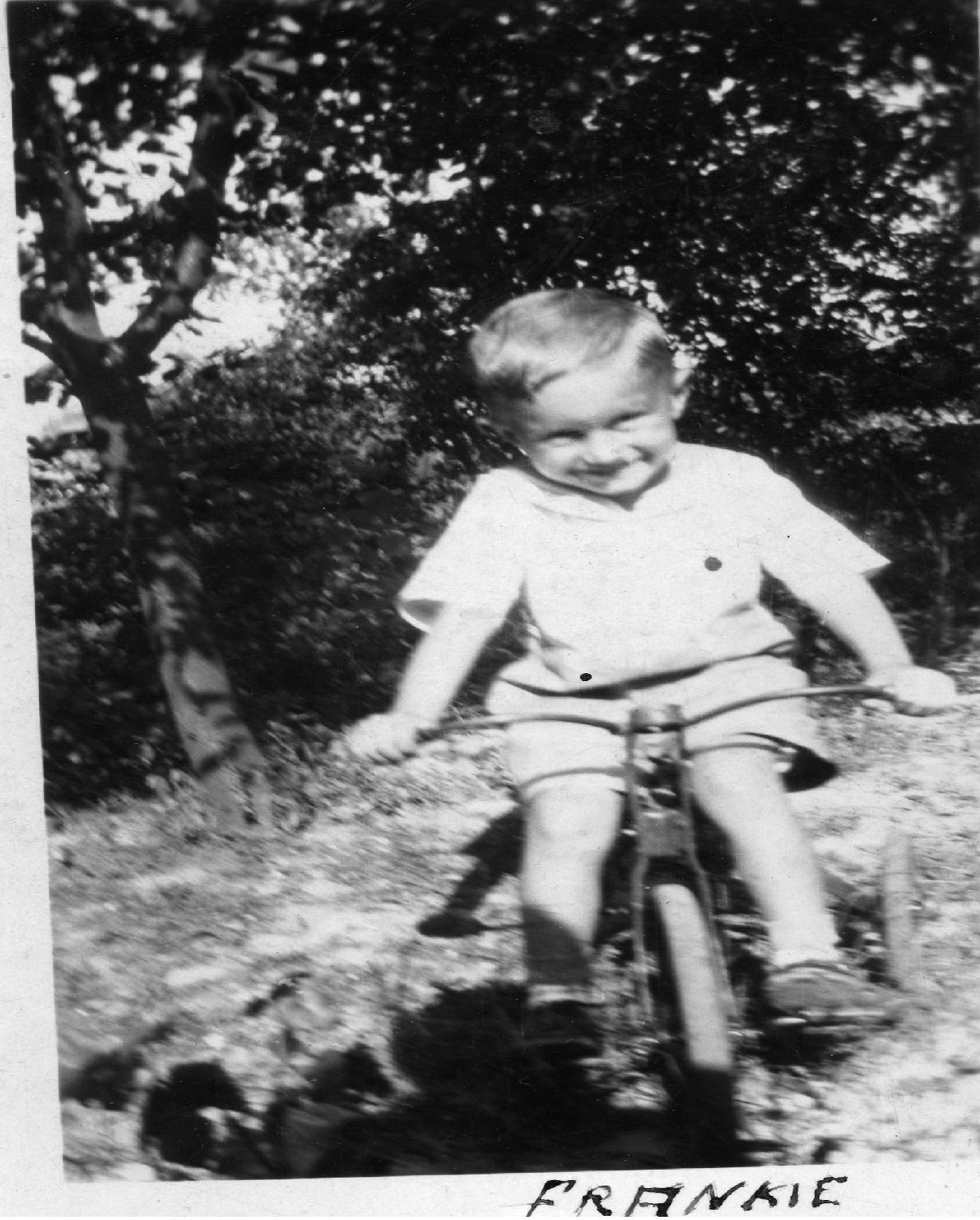 Frank riding a tricycle