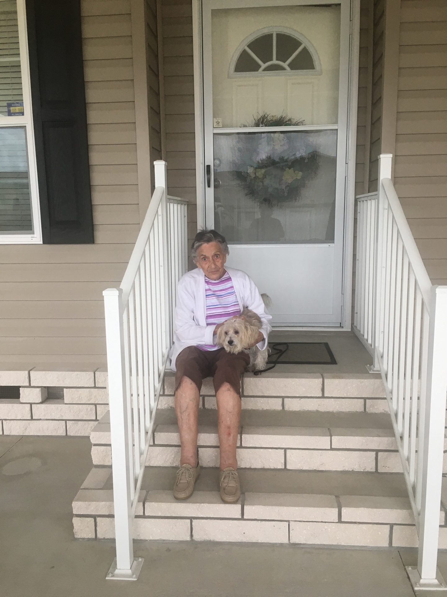 Joyce on the front steps of her house,  with Fitz