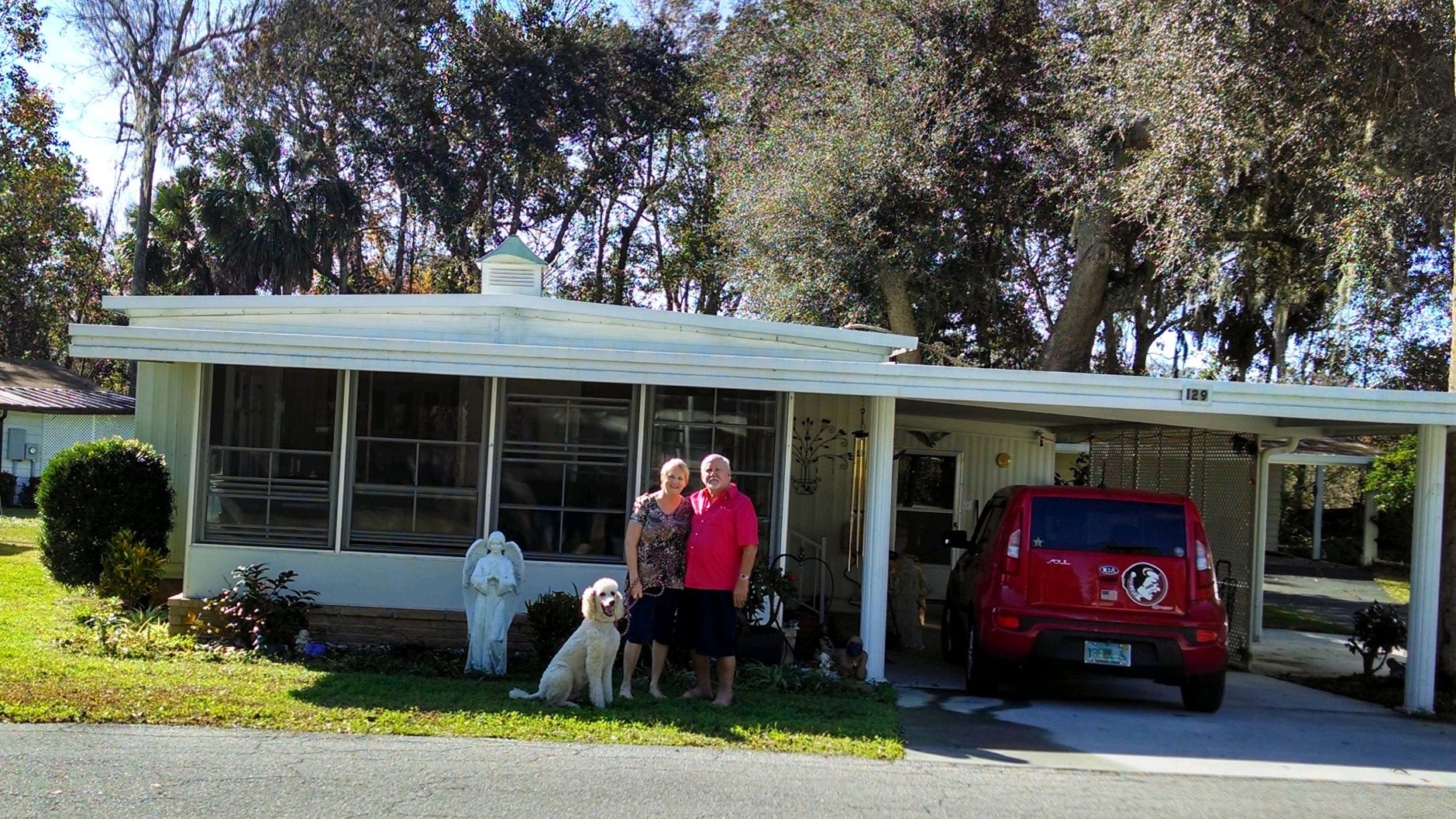 Jean and Mac in front of their home