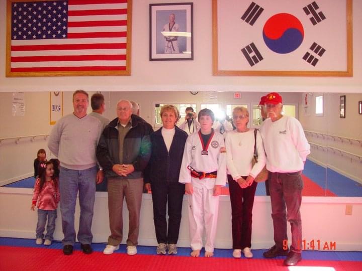 Brandon with his grandparents, Uncle & Cousin after his first Dan black belt test.