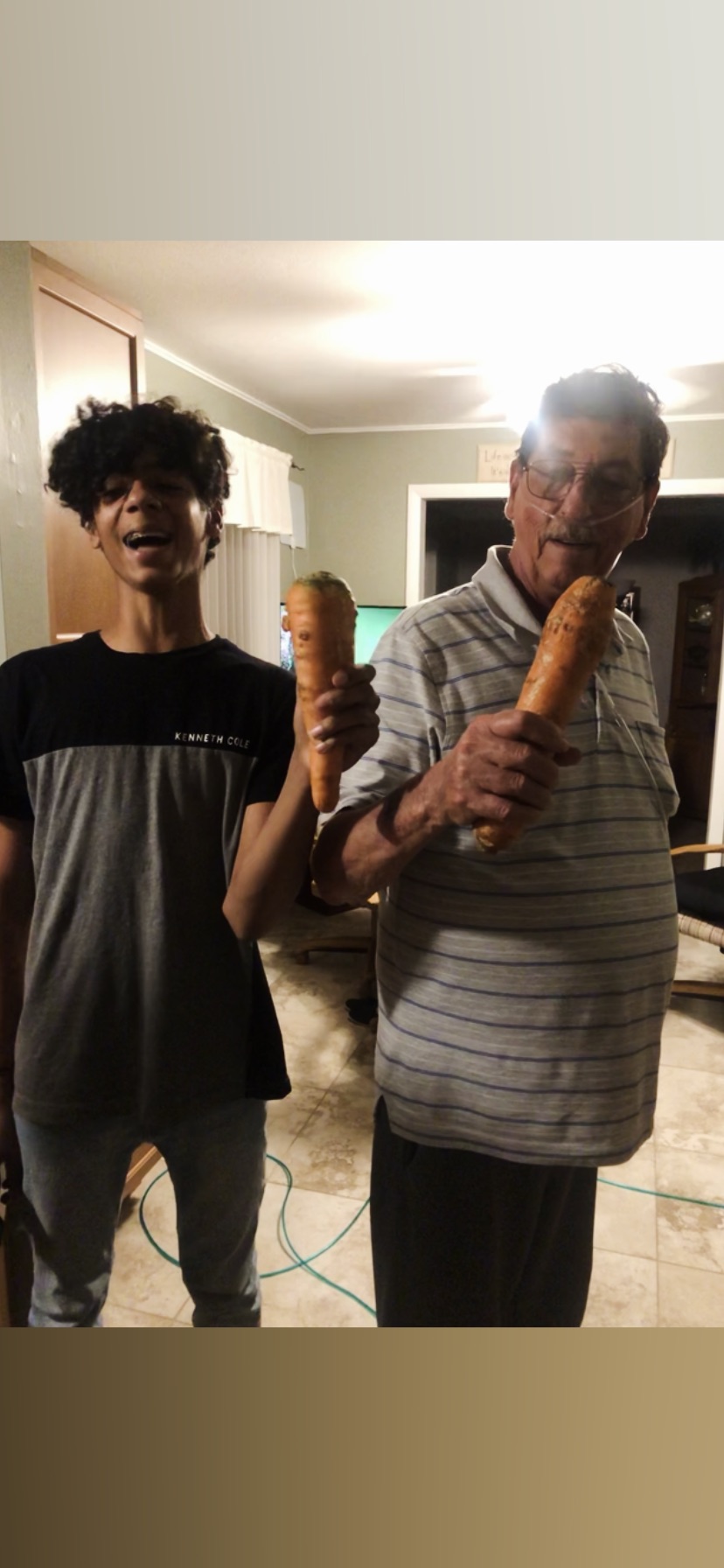 Caleb and dad having fun with giant carrots.