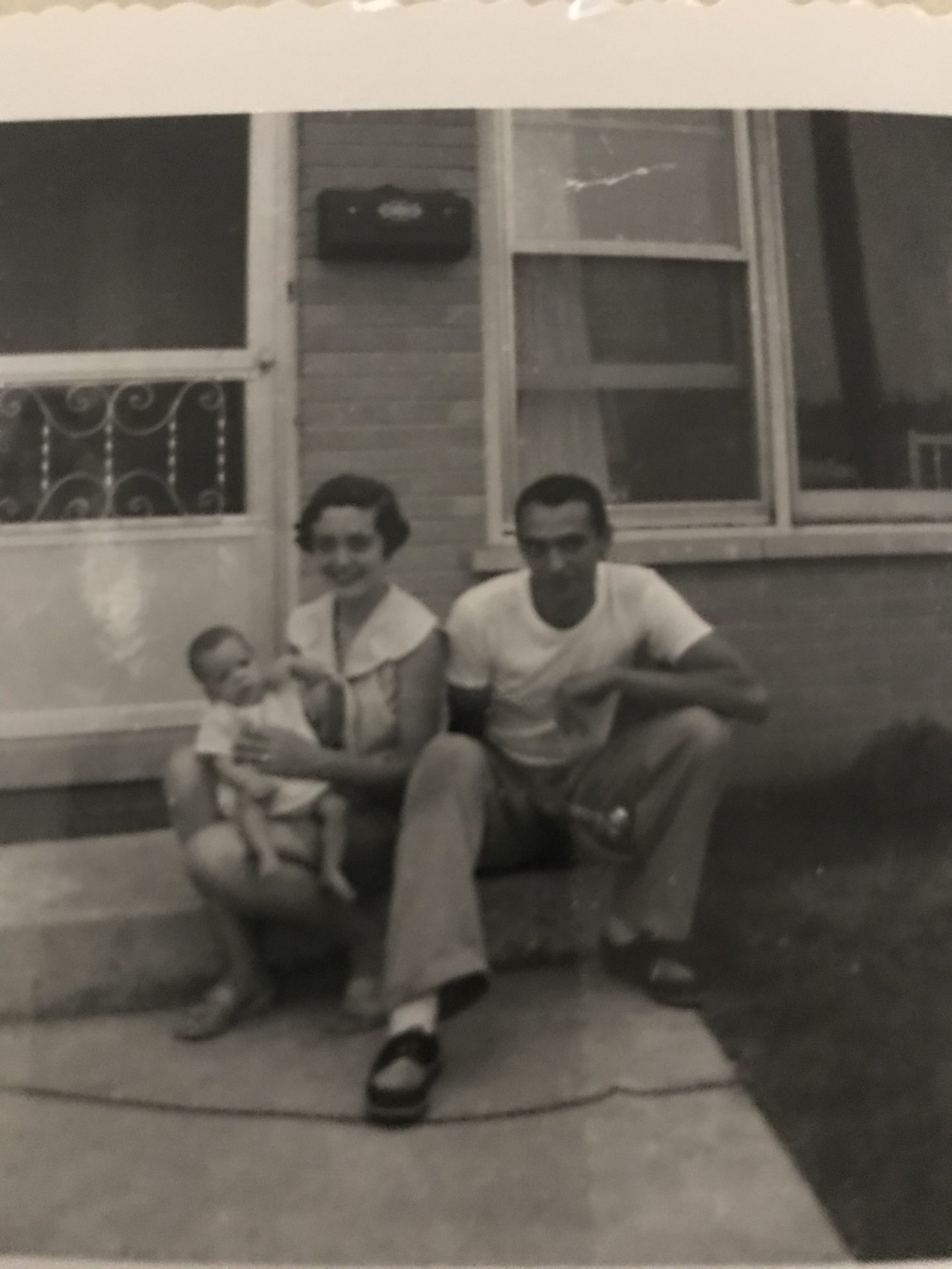 Mom and Dad on porch at our first home in Bellwood around 1960
