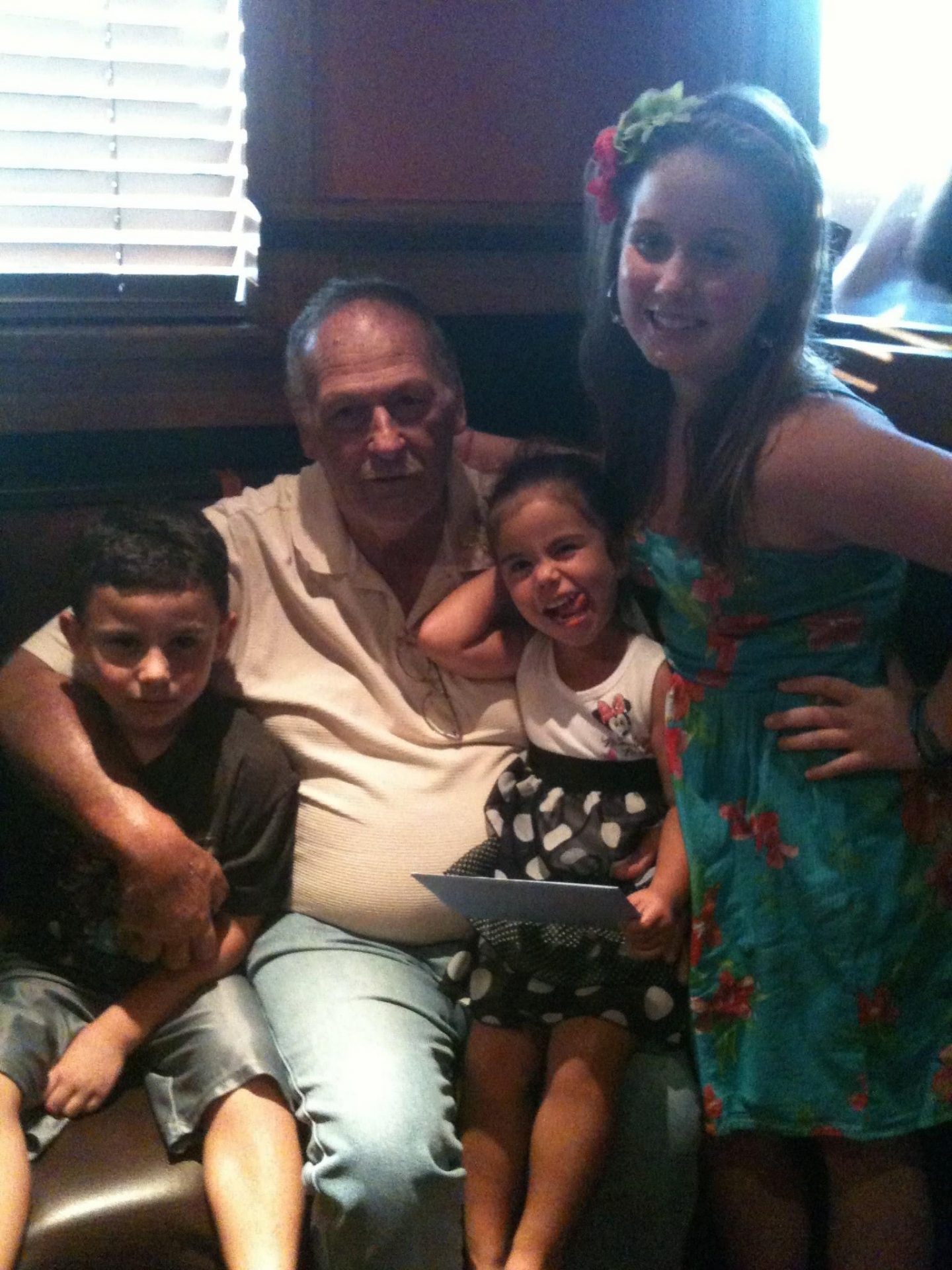 Celebrating one of his birthdays with his grandkids at his most favorite places, Outback.