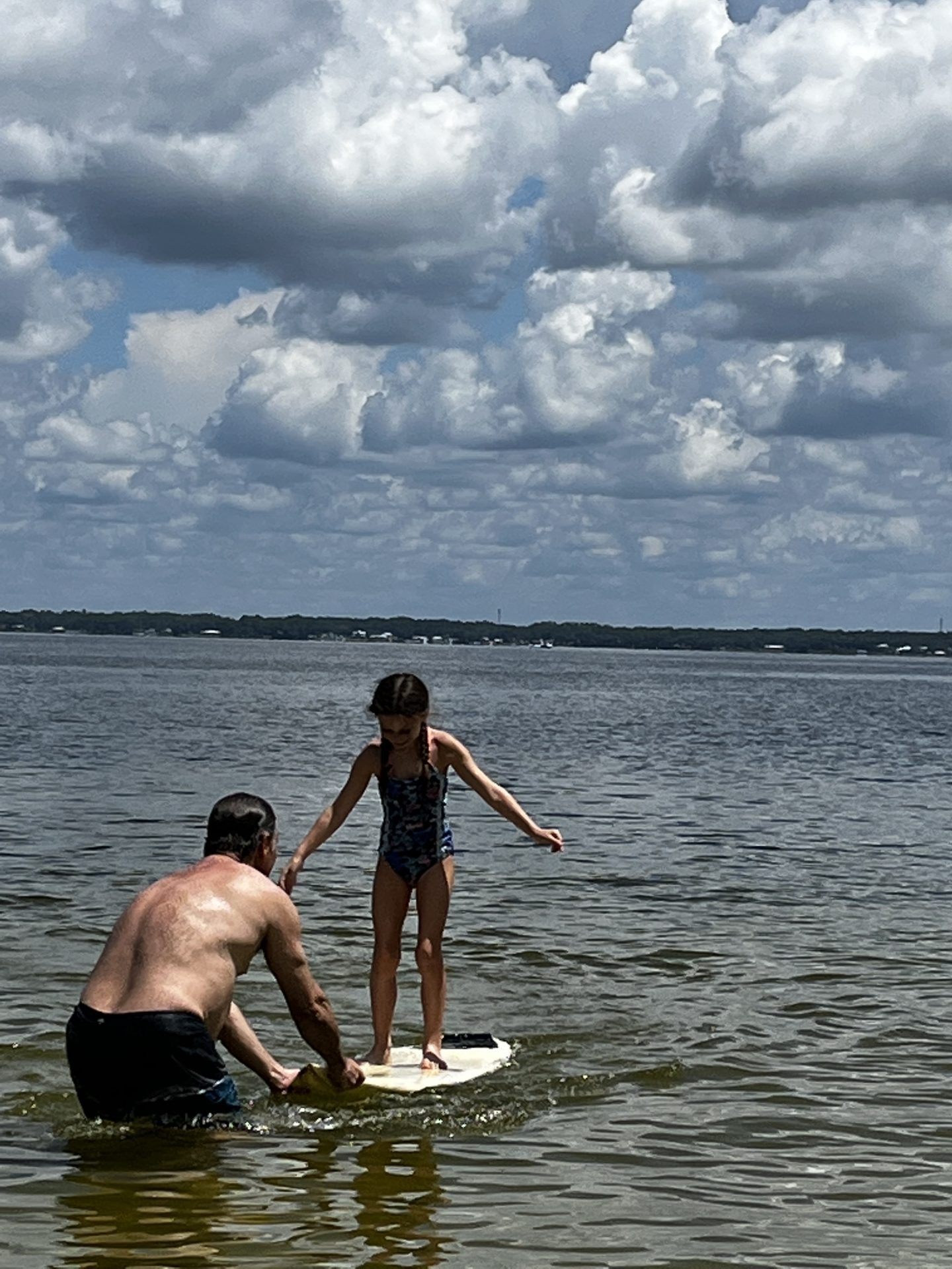 Chris teaching my daughter Aubrey to surf