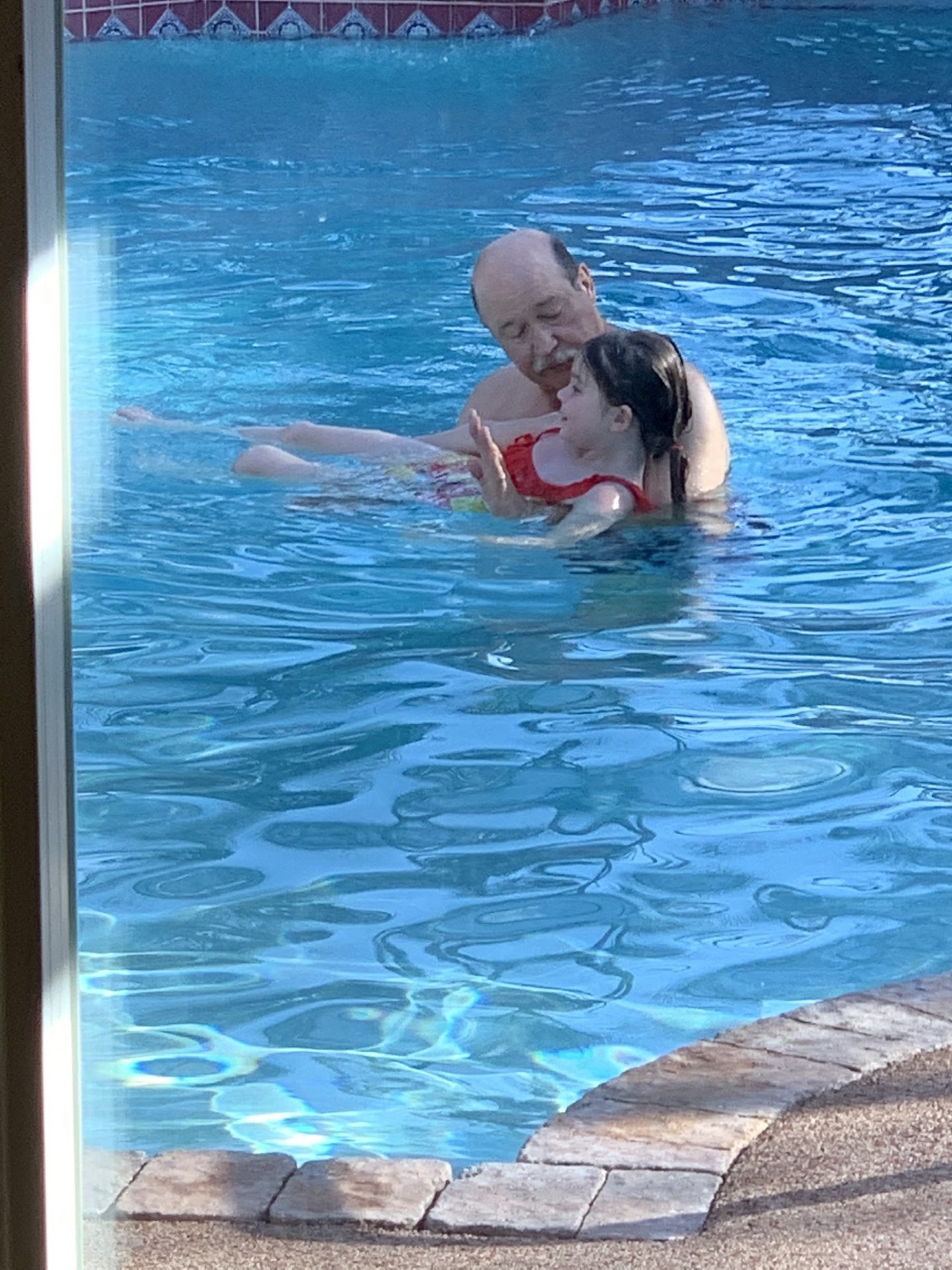 Pa was trying to help his princess learn how to swim