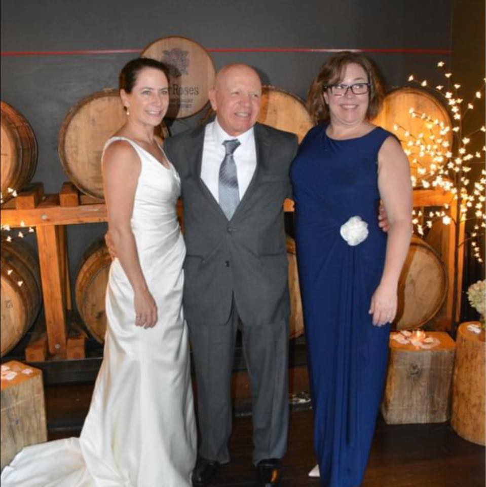Bruce with daughters, Leslie (bride) and Erika