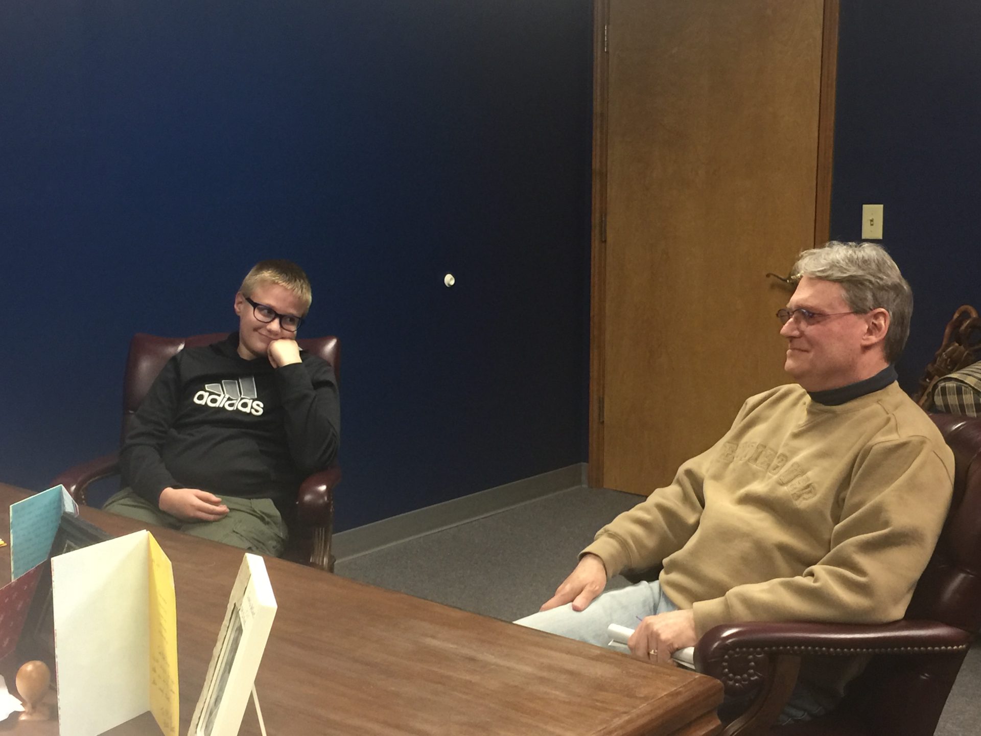 Luke & Dad sitting before the Judge completing the adoption papers.  See how admiring Luke is looking at Dad!  Such a tender heart.