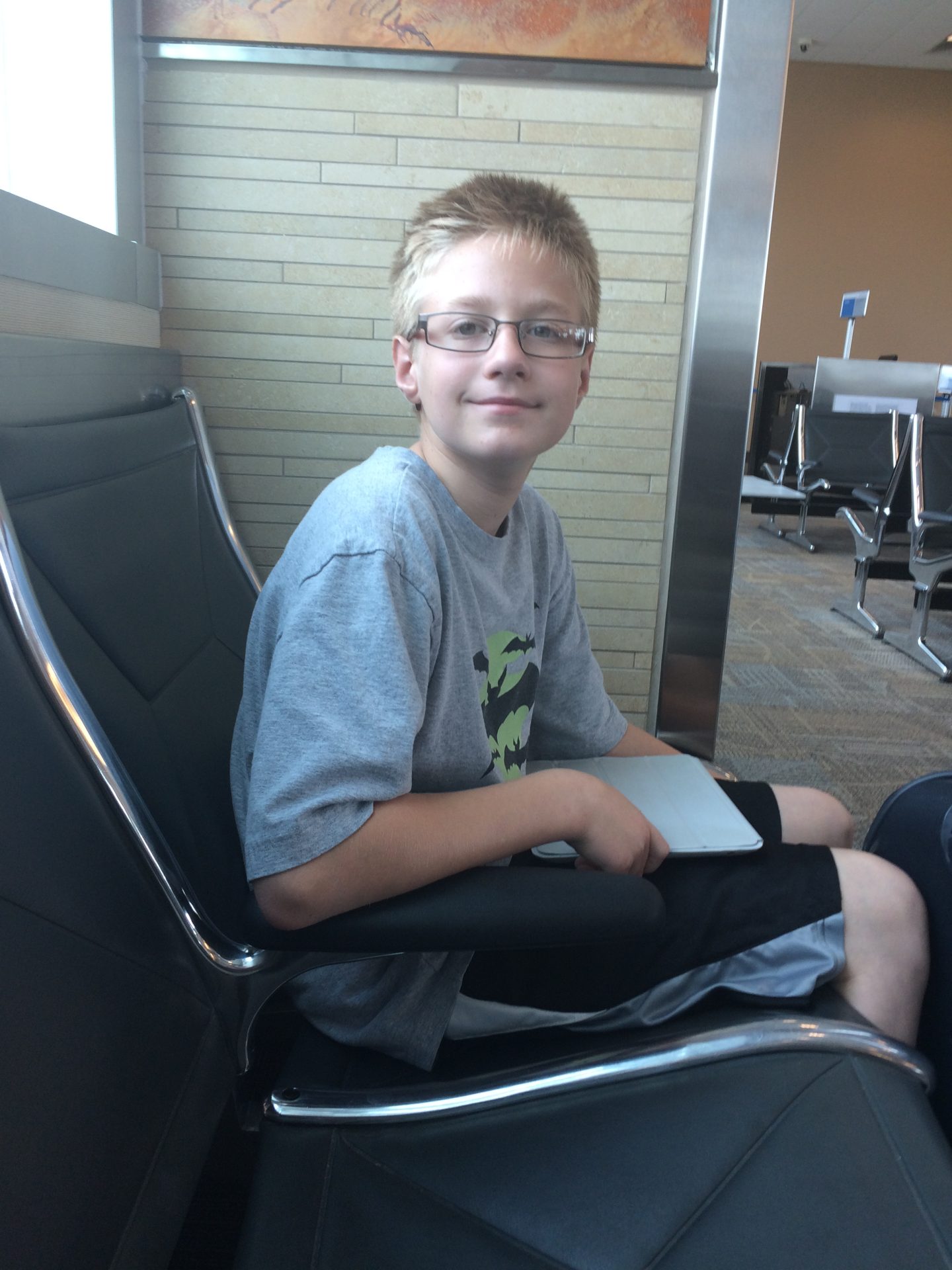 Luke @ the airport waiting to be delivered to Dad in FL.